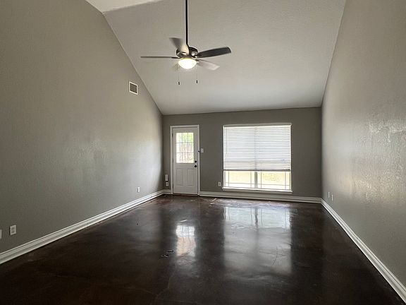 Living room with vaulted ceiling.