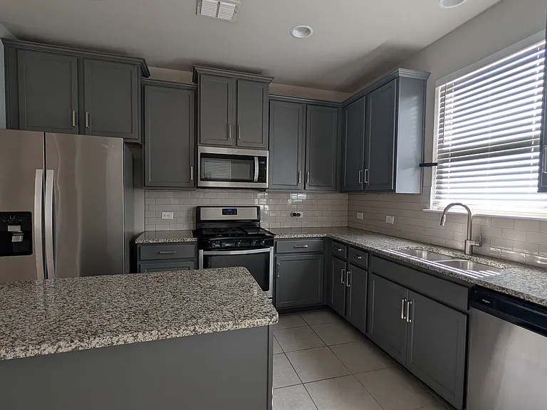 Kitchen with granite counter tops and stainless steel appliances