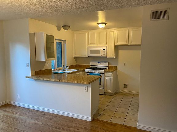 Brand new refrigerator installed. Pantry is to right of fridge - custom cabinets, washer and dryer.