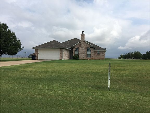 Beautiful front view of large 1-acer lot and extended driveway.
