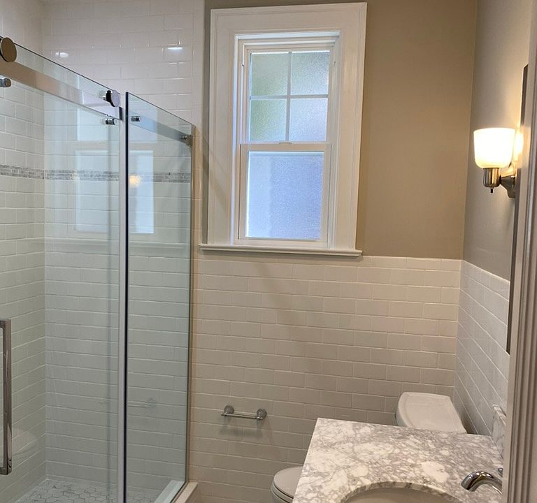 New bath with marble tile and counters