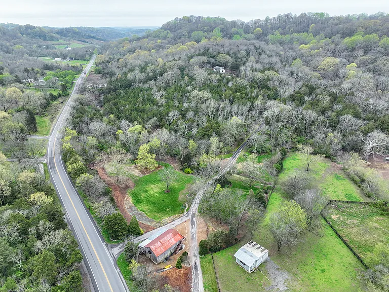 Aerial view of front of property showing historic barn and front pasture