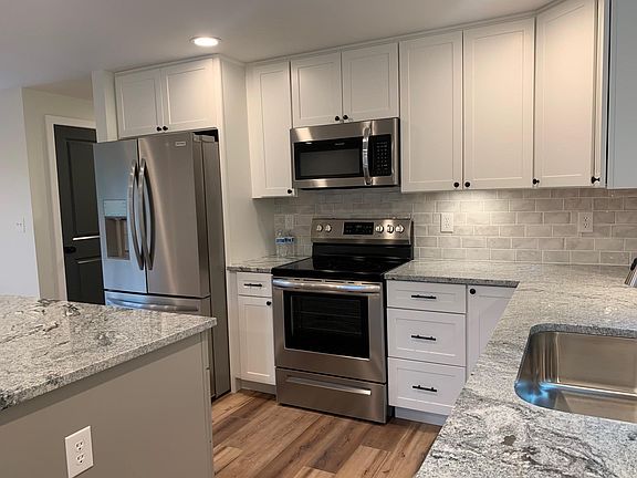 Kitchen w/ stainless steel appliances - electric range, microwave, French door refrigerator and dishwasher
