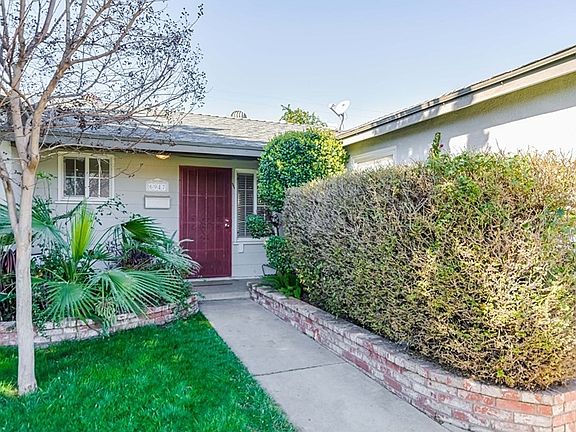 Door color accentuates the brick flower beds.