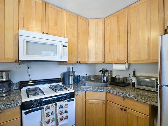 Granite counter tops and gas stove with built-in microwave.