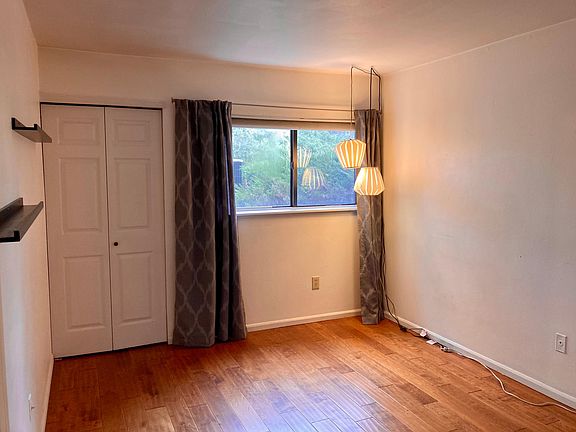Bedroom has hardwood floors and two closets