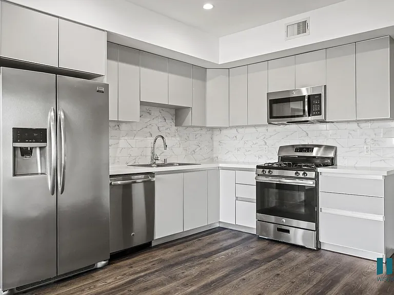 Kitchen with Energy-Efficient Refrigerator, Dishwasher, Stove, and Microwave Oven