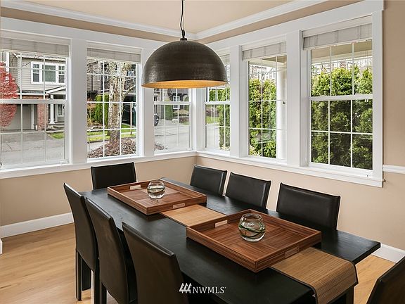 Elegant dining room has fully trimmed windows.