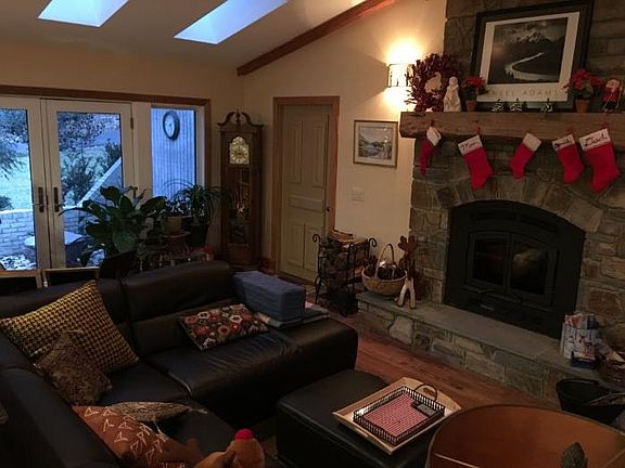 Living room with stone wood-burning fireplace