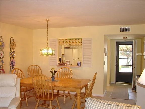 Looking from the living area into the dining area with pass thru to the kitchen.