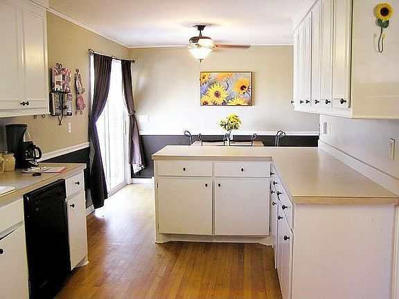This eat-in kitchen includes a breakfast bar and ample cabinet space.