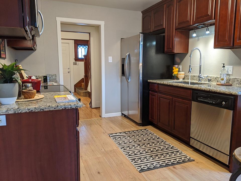 Updated kitchen! Front door and stairs in the background.