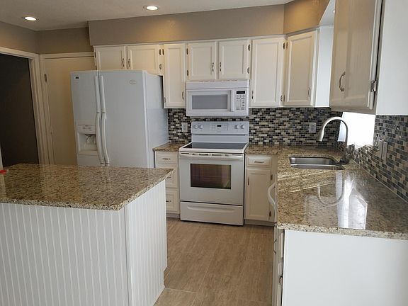 Spacious renovated kitchen with lots of storage and prep space on the island