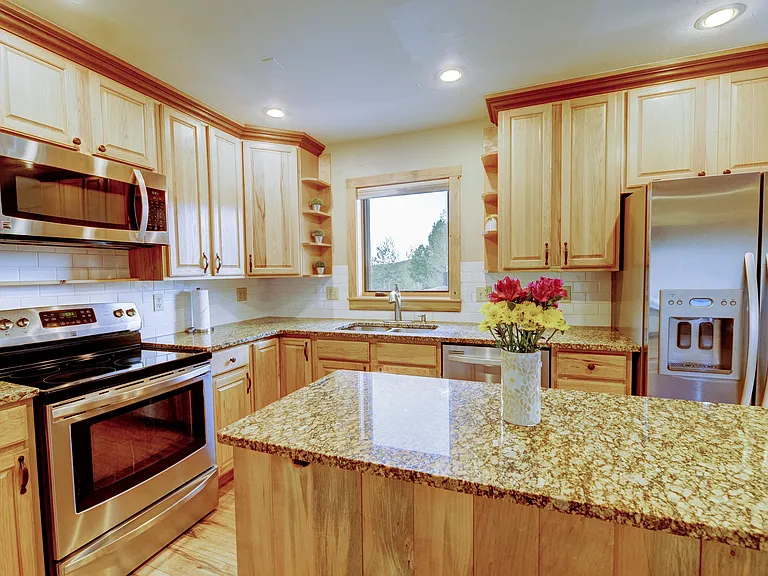 Granite countertops and stainless steel appliances.