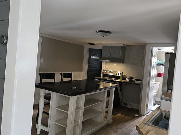 The kitchen thats attached to a bathroom, laundry room and a bedroom.