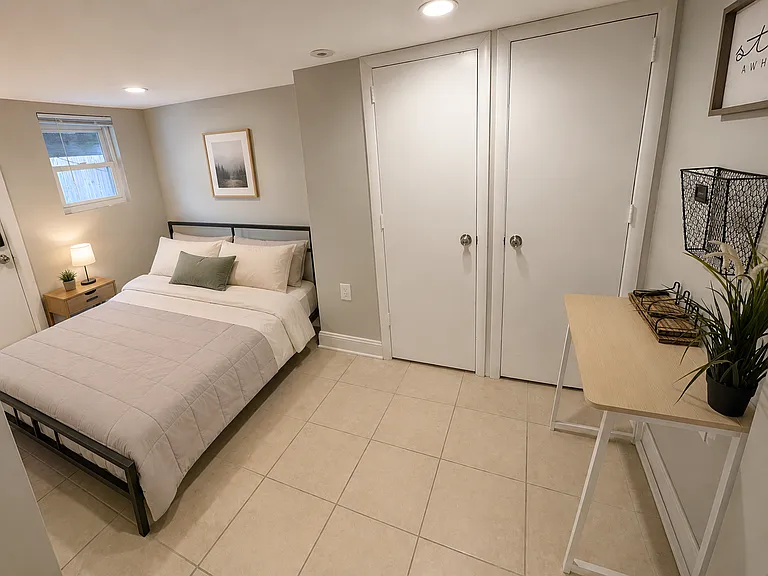 Basement back bedroom. Mattress, desk, wall basket and art available with rental at no cost. Bed frame does not convey.