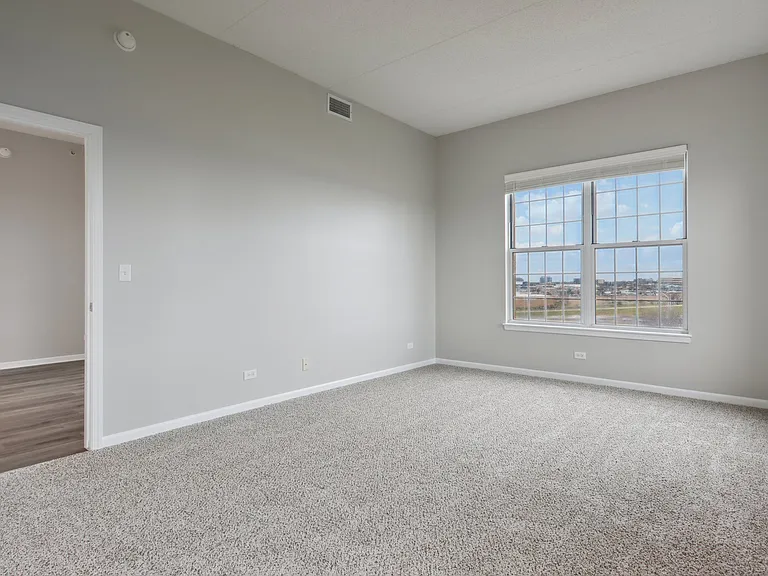 Bedroom with wide window and neutral tones