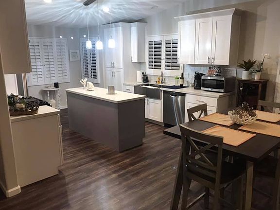Open floor plan modern kitchen with stainless appliances.