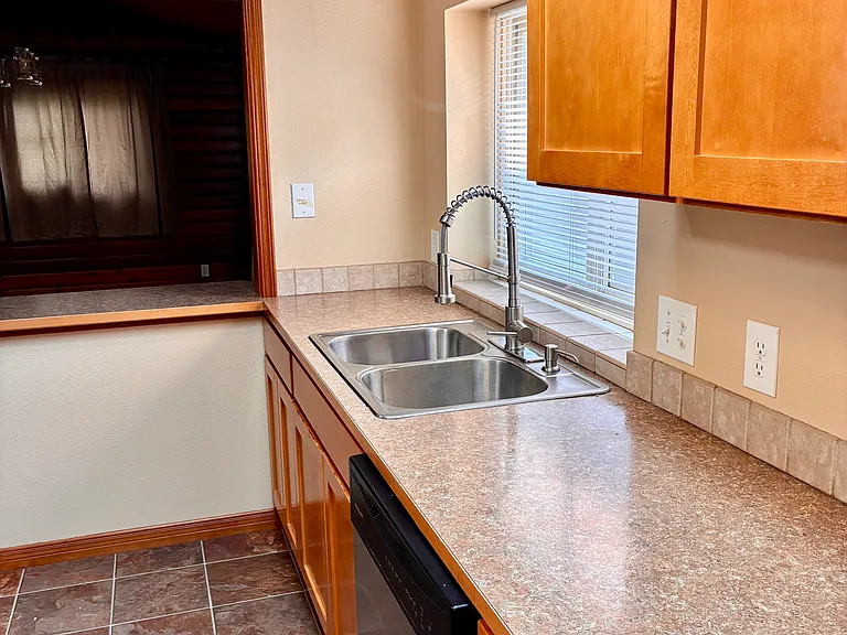 Kitchen area with pass through breakfast bar into dining area.