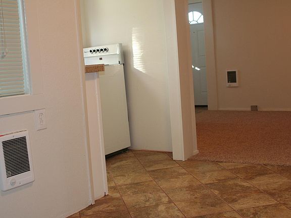 Looking from dining area, small kitchen to left