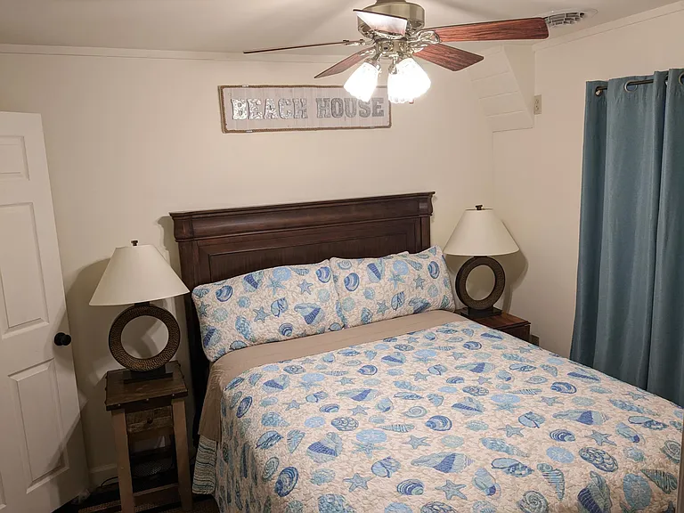 Guest bedroom with queen size bed and walk-in closet