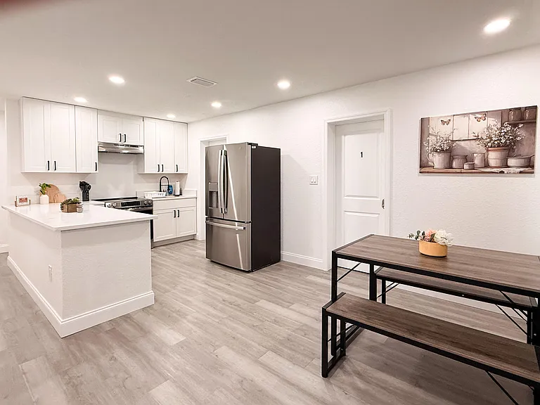 Open kitchen with ample cabinet storage, stainless appliances, and an eat-in dining nook for daily meals.