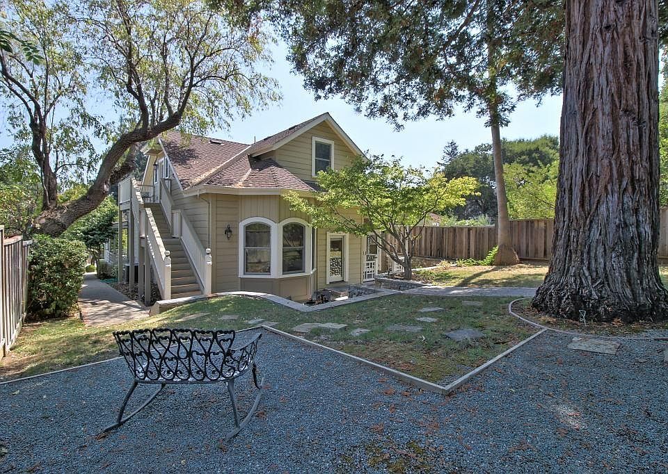 View from the backyard looking toward the rear of the house and the stairs leading to the upstairs cottage for rent