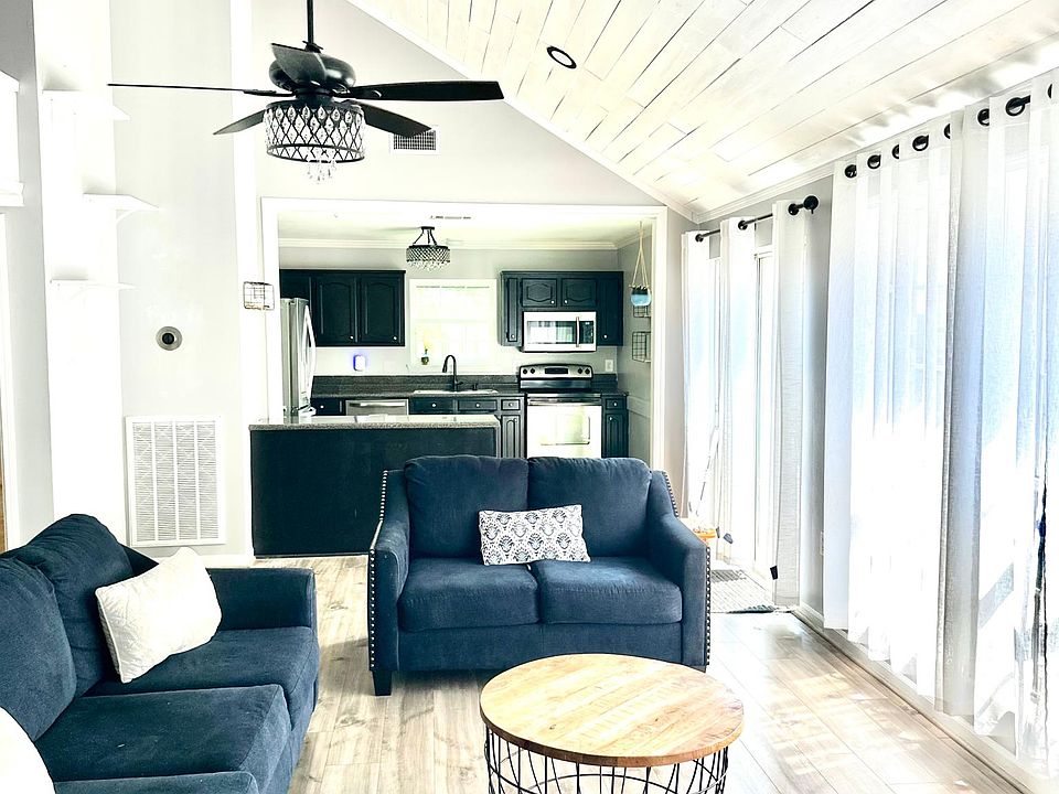 Living room with kitchen behind.