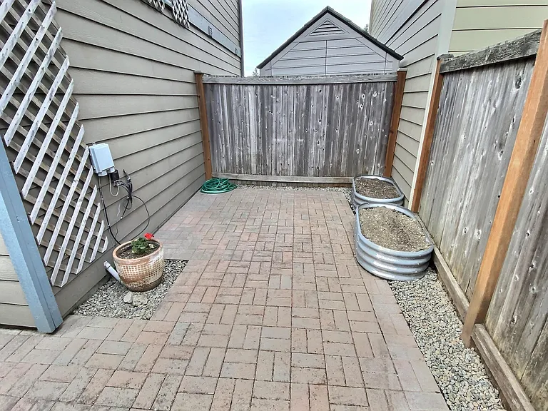 Enjoy a sunny, fenced in, private patio that's perfect for container gardening, outdoor dining, grilling, or relaxing with your morning coffee.
