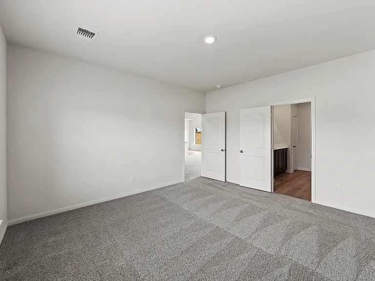 The master suite has a large bedroom, en-suite bathroom and walk-in closet.