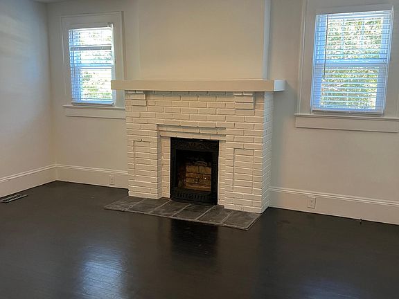Original fireplace (sealed) and Tiffany light fixture illuminates your living room and entry, providing interest and character.