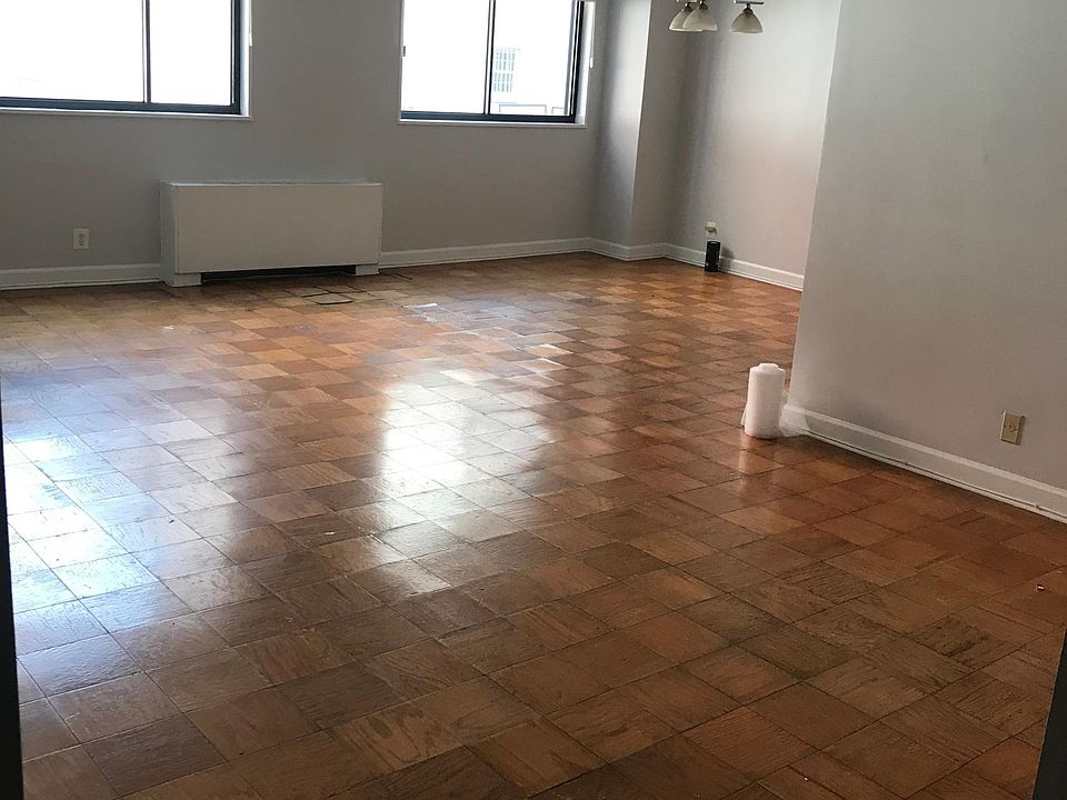 Living room and dinning room, facing a back alley. Space on the left could be used as a home office.