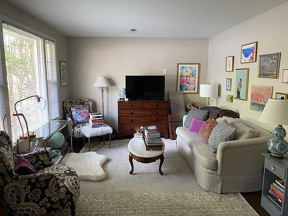 Living room with triple windows. All windows have been replaced Beautifully refinished hardwood flooring.