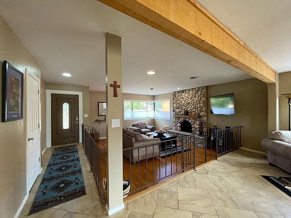Front entry and den, featuring gorgeous stone fireplace