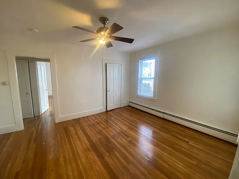 Bedroom has closet and beautiful hardwood flooring