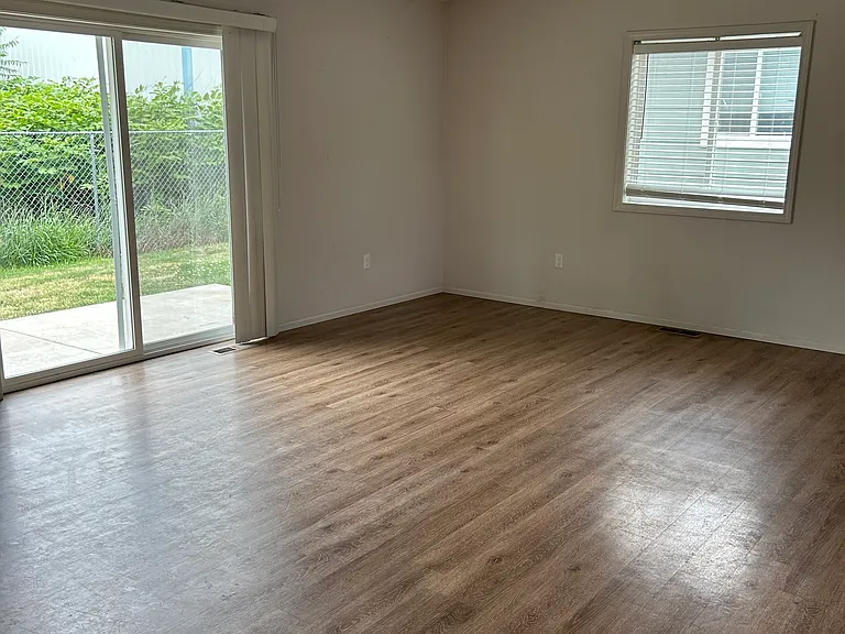 Another view of living room with vaulted ceiling