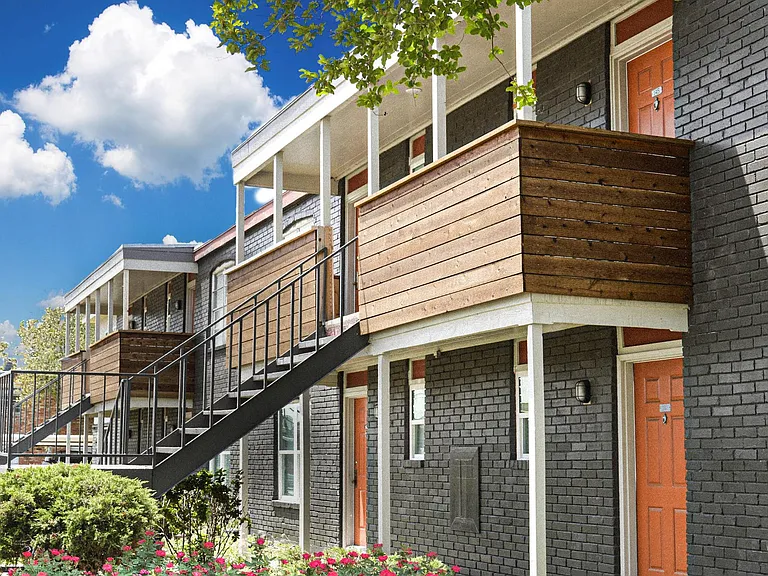 Modern balconies and manicured greenery enhance curb appeal at Christy Estates Apartments.