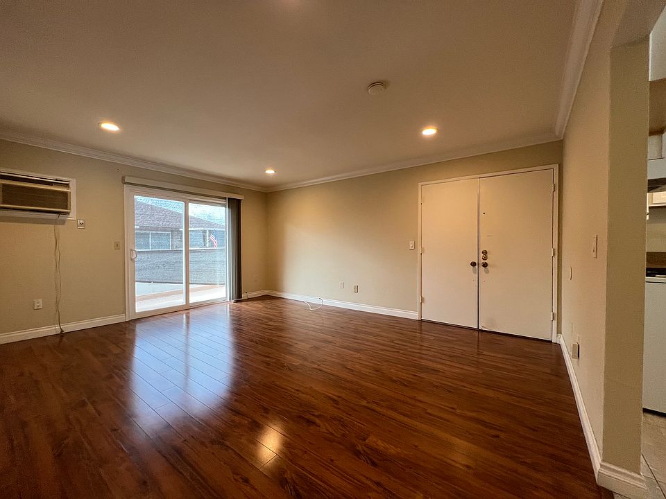 Living room with double door entry and updated sliding glass door to patio