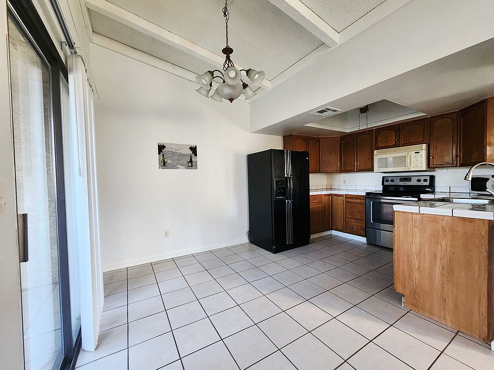 Vaulted ceilings in the kitchen and dinning area with easy to maintain tile floors and counter tops