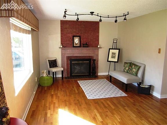 Living Room with large picture window and wood burning fireplace!