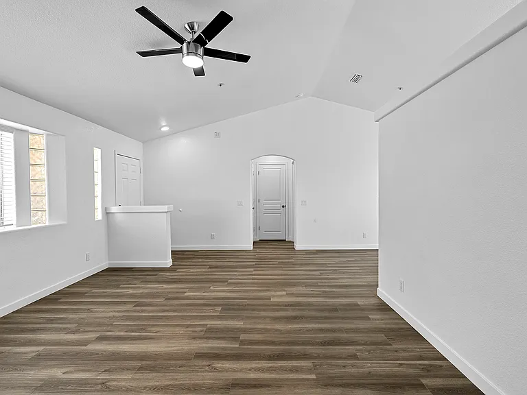 Hallway 1 looking into living room. Straight across in Hallway 2; Left door is entrance to the garage, Center door is a coat closet, Right door is Master bedroom and bathroom.