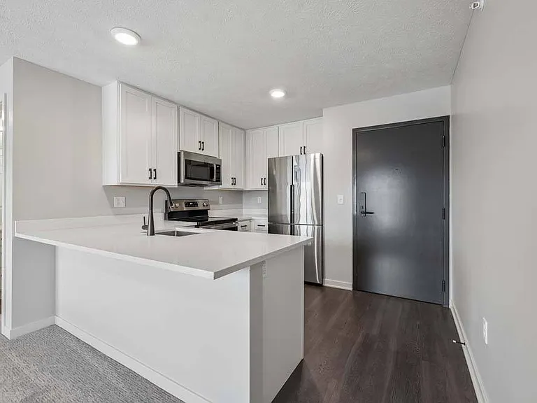 A sleek peninsula, modern finishes, and bright surroundings create a welcoming space designed for effortless living.