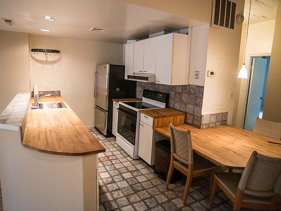 Galley-style kitchen with wood countertops
