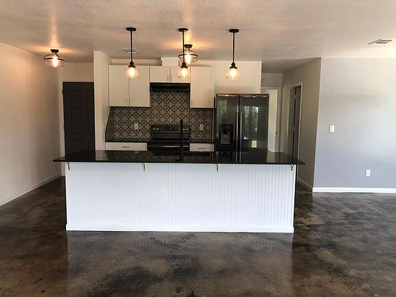 Fully remodeled kitchen with 9' breakfast bar and granite counter top. Italian tile back splash. New appliances.