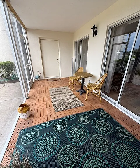 Screened lanai with cafe table and door to laundry room
