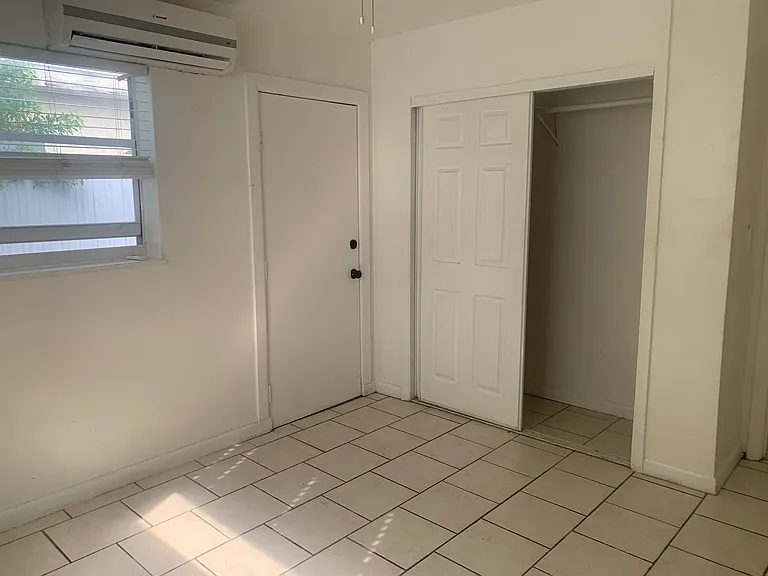 Bedroom 1 with rear area access. Roomy closet