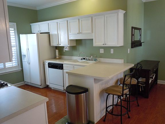 Spacious kitchen with tons of cabinets and a pantry.