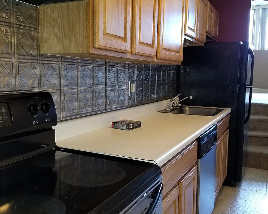 Beautiful galley kitchen with tin backsplash