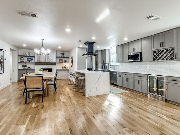 Open-concept living space featuring wide plank wood-finish flooring