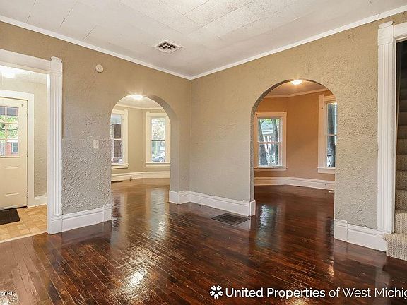 Main entrance area / dining room. Arch on the right leads to a den area / office or formal dining room